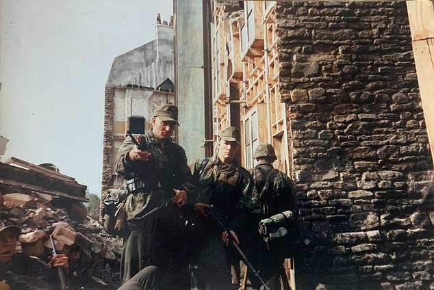 Mike's friend Andy standing with a rifle