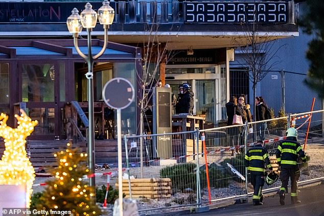 Rescuers are seen at the site of an explosion that ripped through a bar in Crans-Montana on January 1, 2026