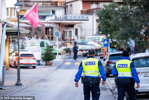 Police officers walk at the site of an explosion that ripped through a bar in Crans-Montana on January 1, 2026