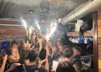 A photo appears to show the moment champagne sparklers set fire to material on the ceiling of the Swiss nightclub
