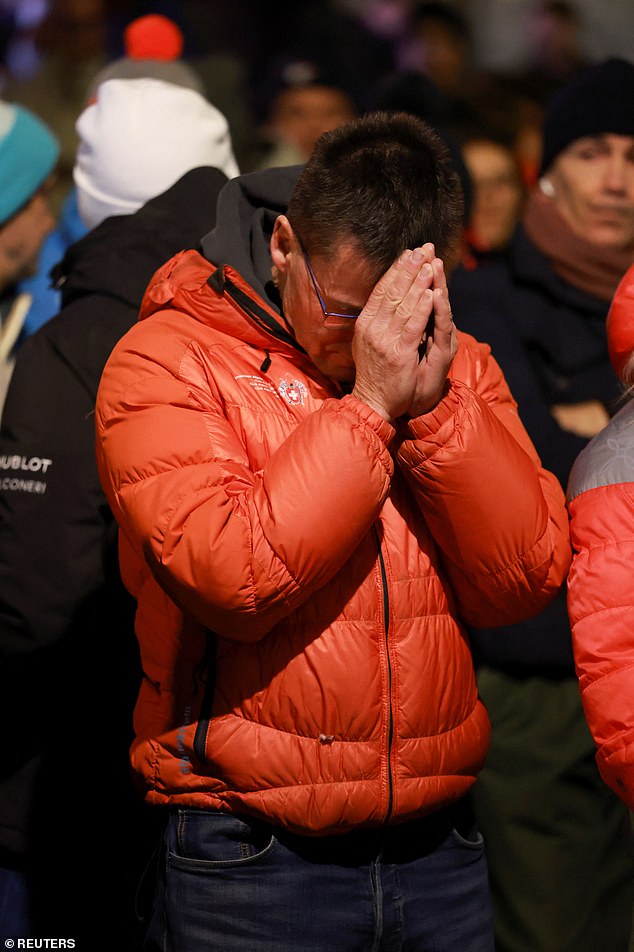A man reacts outside the "Le Constellation" bar, after a fire and explosion during a New Year's Eve party where several people died and others were injured, according to Swiss police, in the upscale ski resort of Crans-Montana in southwestern Switzerland, January 1, 2026