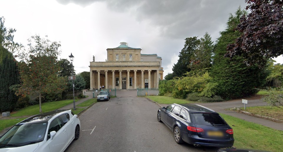 Pitville Pump Rooms, a neoclassical building with a colonnade, seen from a parking area.