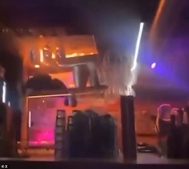 Panicked partygoers can be seen rushing to escape the venue, while others seem to remain underground filming the blaze, evidently not yet realising its danger