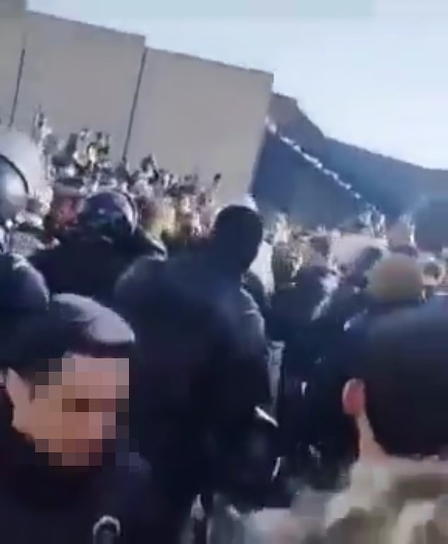 Protesters and security forces clashed in several Iranian cities on Thursday with six reported killed in the first deaths since the unrest escalated. Pictured: Screengrab of footage shared online which appeared to show protesters clashing with the security force