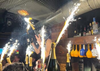 Images show the moment before a deadly New Year's Eve blaze a Swiss ski resort bar killed 47 people. A waitress had been seen dancing and waving a lit sparkler beneath foam soundproofing panels on the ceiling, which then caught light