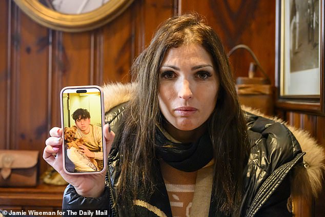 Laetitia Brodard-Sitre holds a photograph of her missing son