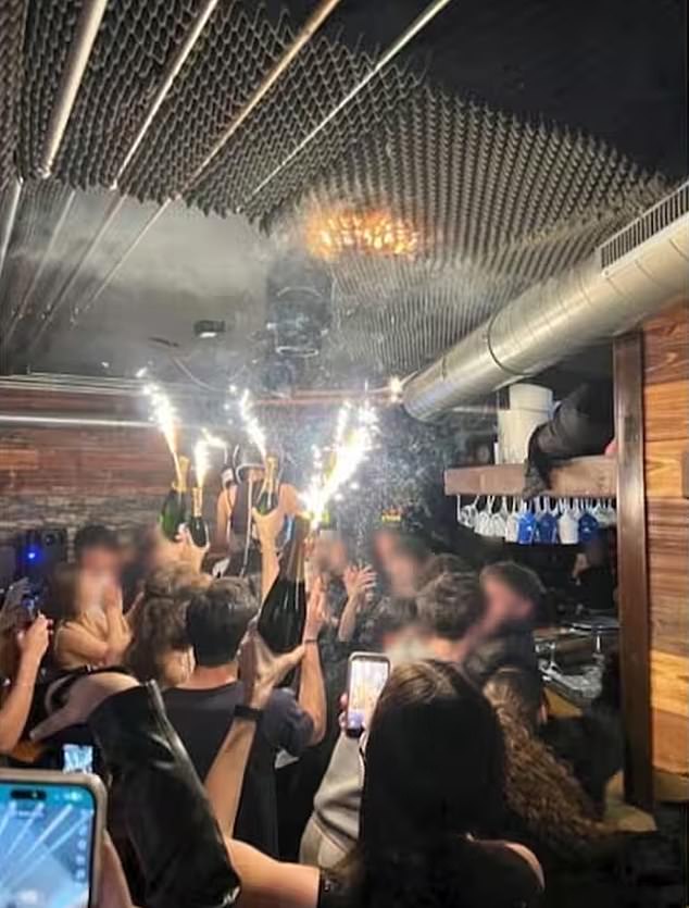 Another photo sent to BFMTV by survivors shows partygoers carrying champagne bottles filled with sparklers, apparently moments before the blaze