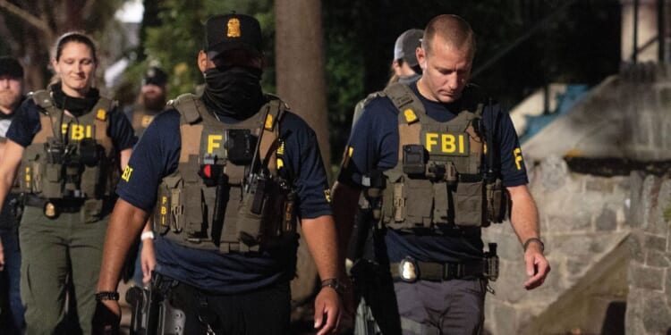 FBI agents walk down Florida Avenue on Aug. 13, 2025 as part of President Donald Trump's deployment of federal officers and the National Guard in Washington, DC.