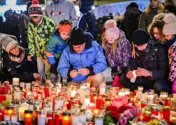 Visitors stood in sub zero temperatures watching the tributes, flowers and candles be laid out