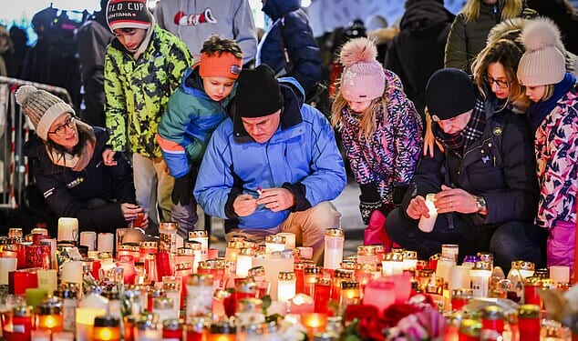 Visitors stood in sub zero temperatures watching the tributes, flowers and candles be laid out