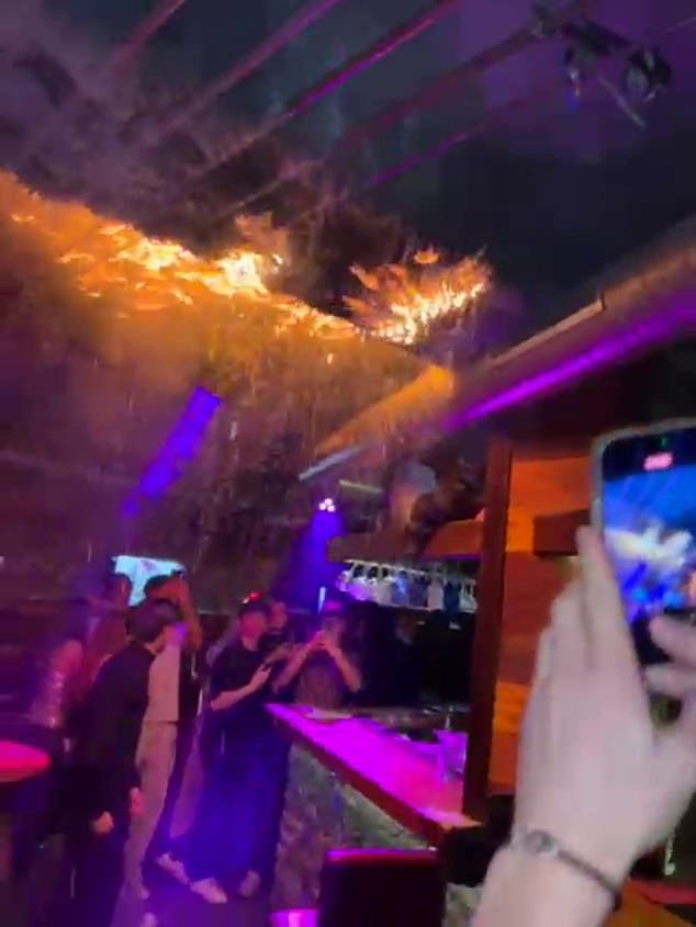 People film the ceiling on fire at the Swiss Constellation Bar fire in Crans-Montana