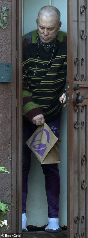 In what is a rare sighting of the star, Rourke appeared briefly from his home to pick up food dropped off at his doorstep