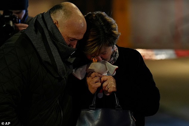 A woman whose daughter is still missing clutches a soft toy