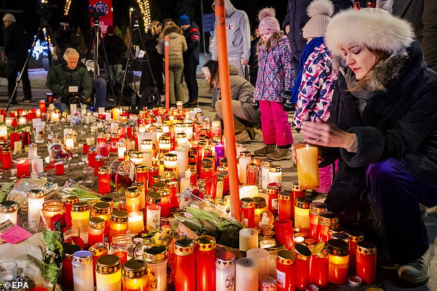 Flowers and candles have been laid outside Le Constellation in memory of the victims