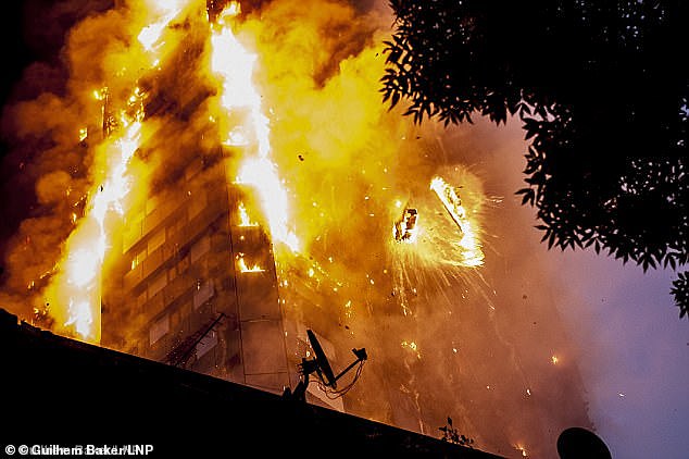 A picture of debris falling from Grenfell tower in 2017 as flames tear through the high-rise