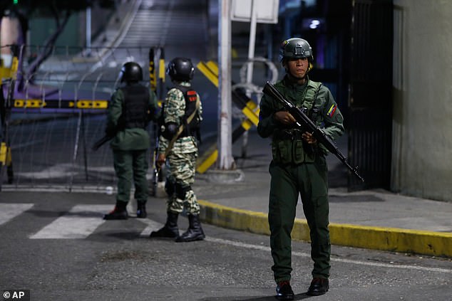 Soldiers guard the area around the Miraflores presidential palace after explosions and low-flying aircraft were heard