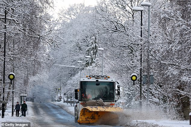 A snow plough attempts to make the roads safety amid plunging temperatures in Scotland