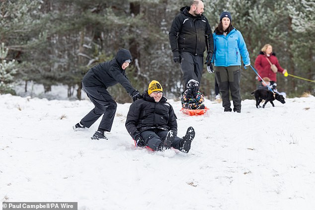 People sledging in Loch Morlich, Aviemore, after amber weather warnings were issued