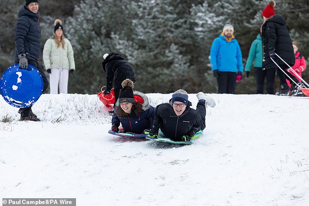 People sledging at Loch Morlich in Aviemore in the Scottish Highlands on Friday afternoon