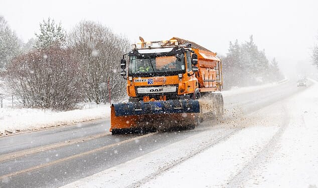 A Gritter lorry on the A9, south of Inverness, attempts to tackle the piling snow on the road