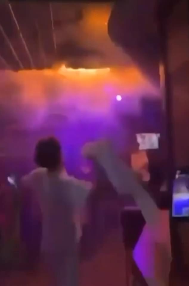 Footage from the evening shows a brave reveller trying to put out the first flames as they spread across the wooden ceiling of the cramped basement bar in south-west Switzerland
