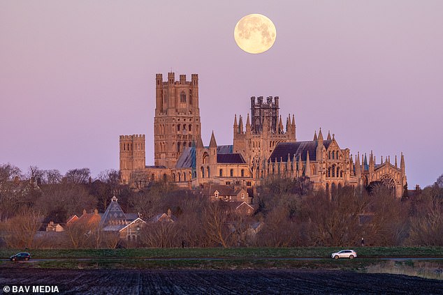In Ely, Cambridgeshire, the supermoon has been seen rising above the city's cathedral