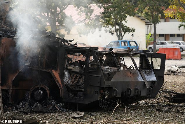 A military vehicle destroyed by Saturday's strikes in Venezuela is seen burned-out as dawn breaks in Caracas on Saturday morning