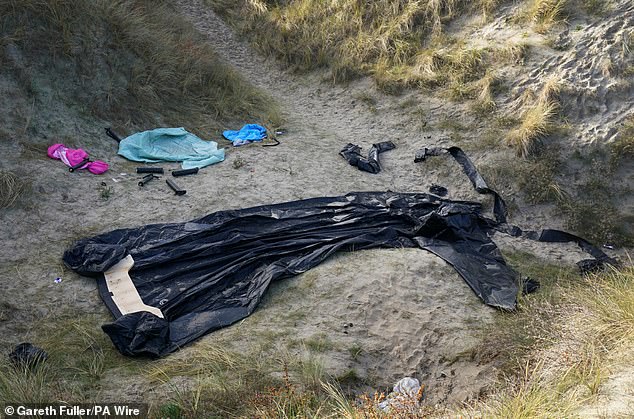 Debris of a small boat used by people thought to be migrants to cross the Channel lays amongst the sand dunes in Gravelines, France, on December 11