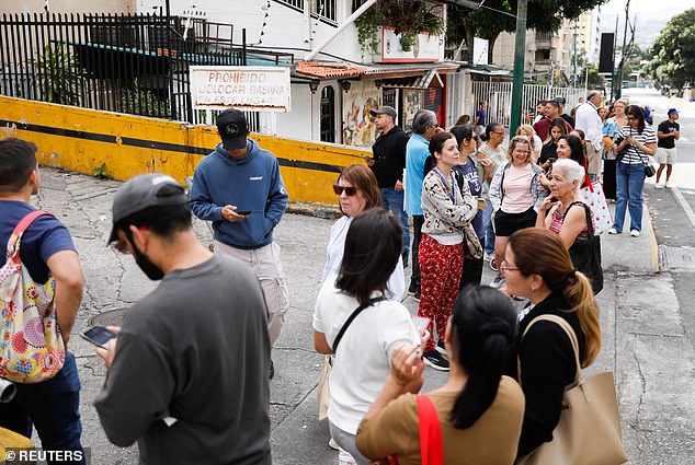 Venezuelans are photographed lining up outside a supermarket on Saturday morning after the country's president Nicolas Maduro was captured by the US
