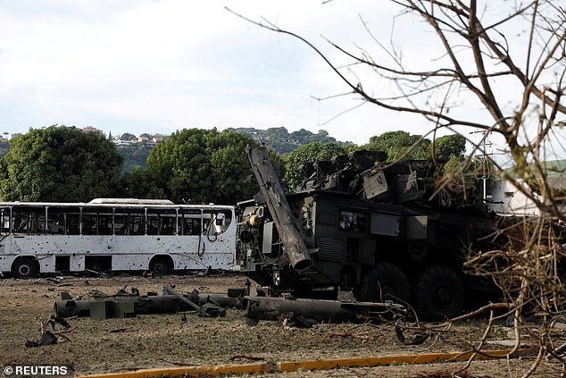 A destroyed anti-aircraft unit is seen burned out next to a destroyed bus at La Carlotta military air base in Caracas hours after Friday's US operation in Venezuela that saw the country's president and first lady seized by US special forces