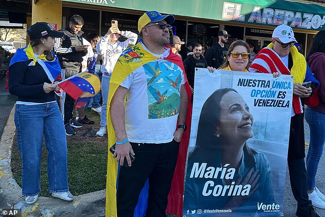 Supporters holding a banner of opposition leader and Nobel Peace Prize winner Maria Corina Machado amid celebrations following news of Venezuelan President Maduro's capture