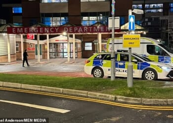 Police vehicles are seen outside the A&E entrance to Bolton Hospital on Friday evening