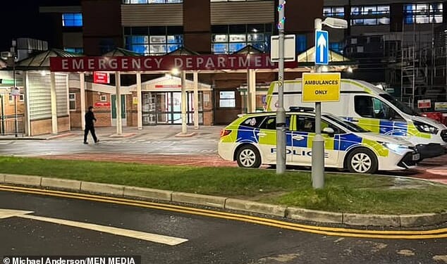 Police vehicles are seen outside the A&E entrance to Bolton Hospital on Friday evening