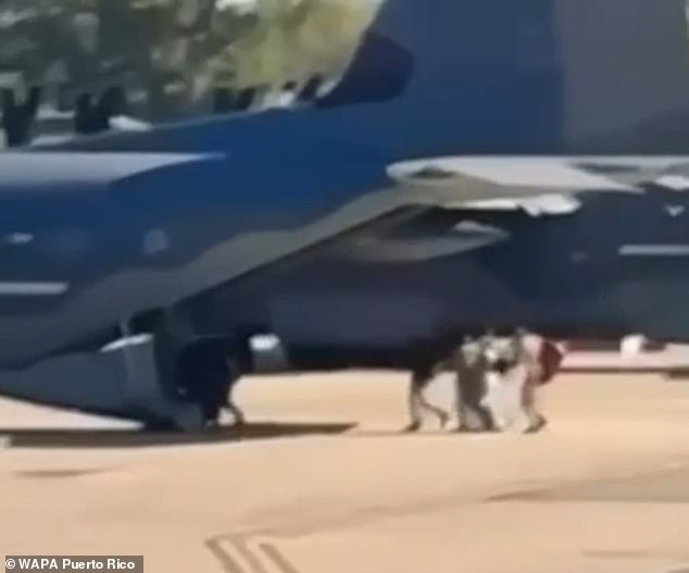 New video appears to show Nicolás Maduro and his wife being frog-marched onto a military plane at a Puerto Rican air base as part of their extradition to the US. Shot from several hundred yards away, the video shows a huddle of people boarding the aircraft, as shown above