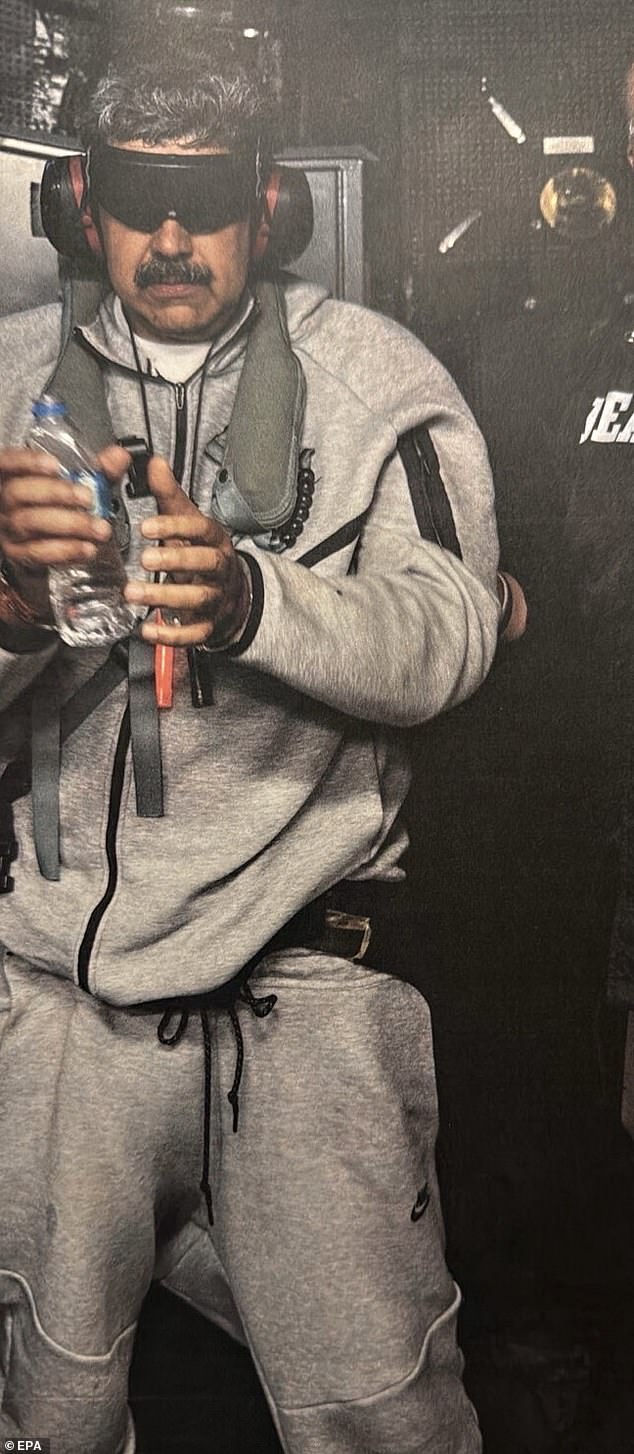 A handout picture made available by the White House Press Office shows the Venezuelan President blindfolded aboard USS Iwo Jima