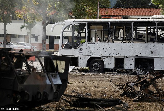 A bus with its windows blown out is seen in Caracas in the early hours of Saturday
