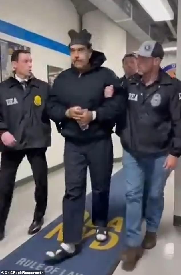 Venezuelan President Nicolas Maduro has been seen walking down a hallway in an official building in Manhattan, almost 24 hours after he was seized by US troops, as shown above