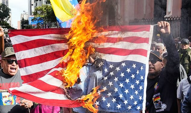 Maduro's supporters pictured burning the US flag in protest of his capture by American forces