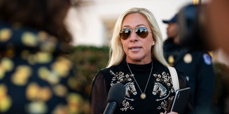 Rep. Marjorie Taylor Greene speaks to reporters while arriving at the Capitol Hill Club for a meeting of the House Republican Conference on March 25, 2025, in Washington, D.C.