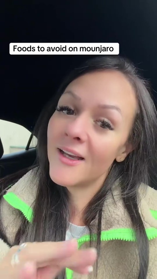 A woman in a car wearing a beige and neon green fleece jacket talks about foods to avoid on Mounjaro.