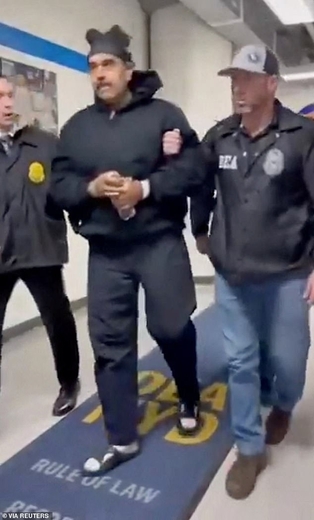 Venezuela's President Nicolas Maduro is seen being taken into custody by US law enforcement officials