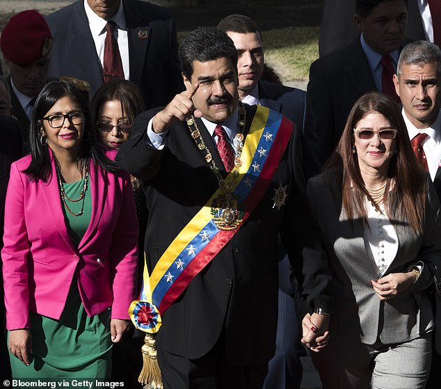 Rodriguez is seen alongside Maduro and his wife, Cilia Flores, in 2018. Flores was arrested alongside her husband this weekend