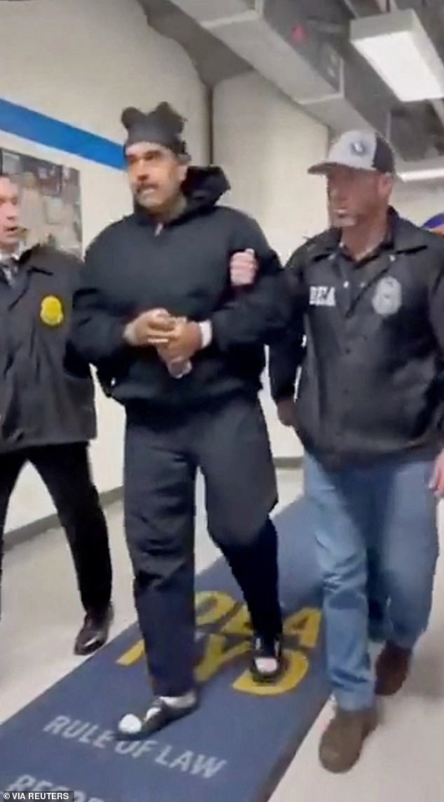 Venezuela's President Nicolas Maduro is seen being taken into custody by US law enforcement officials