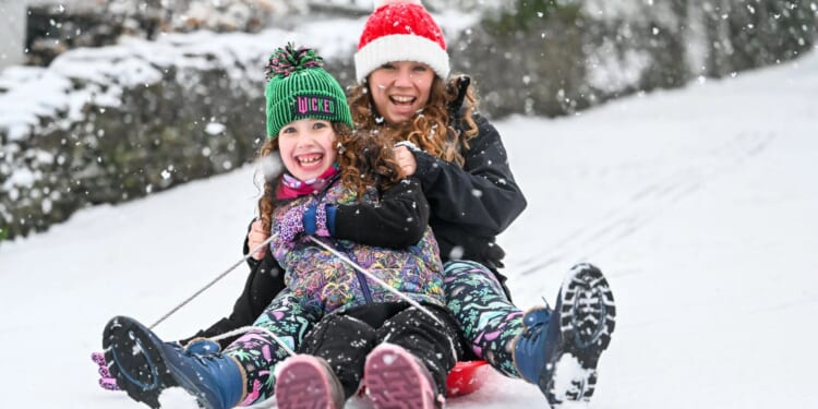 Dozens of schools closed as amber snow warnings hit large parts of UK on return from festive break with up to 3in feared