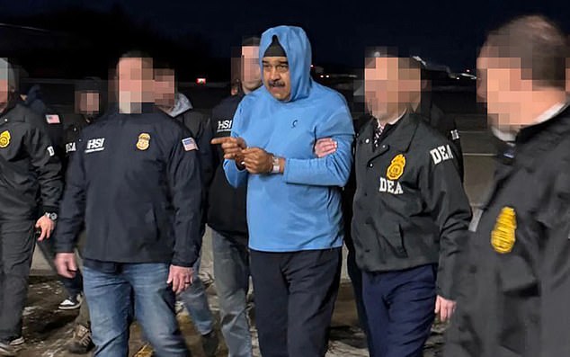 Nicolas Maduro pictured being escorted by DEA agents on landing on US soil following his dramatic capture