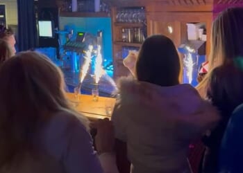 Exclusive footage, obtained by the Daily Mail, shows revellers blissfully dancing shoulder-to-shoulder at the five-star Elizabeth Arthotel's popular Schatzi bar, in Ishgl, Austria, where drinks sparklers can be seen on the counter