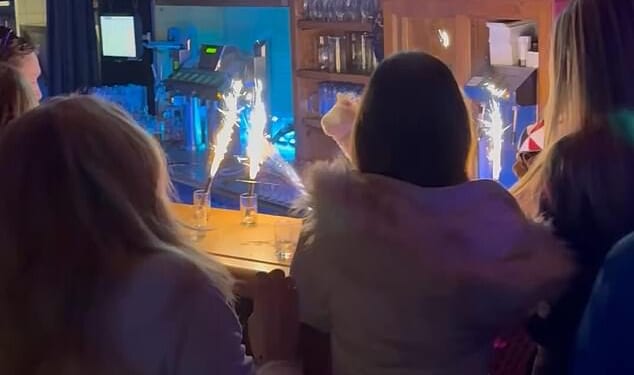 Exclusive footage, obtained by the Daily Mail, shows revellers blissfully dancing shoulder-to-shoulder at the five-star Elizabeth Arthotel's popular Schatzi bar, in Ishgl, Austria, where drinks sparklers can be seen on the counter