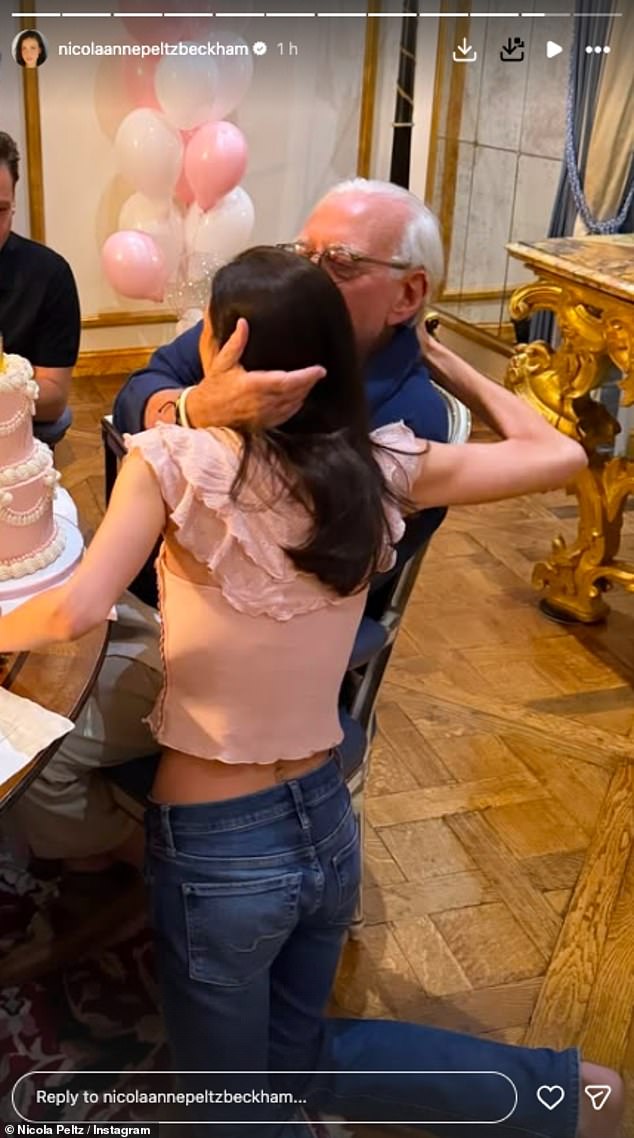 Nicola smiled for the camera and helped her father cut a different cake in another photo