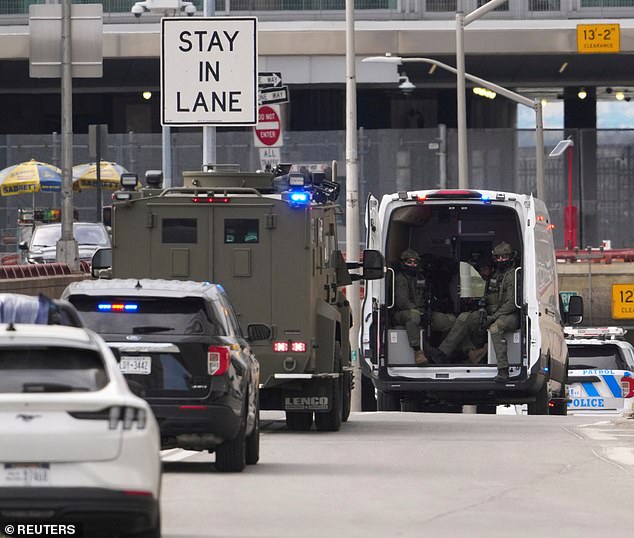Soldiers packed into the back of an open vehicle watched the motorcade as Maduro was driven back to prison to await his next court hearing on March 17