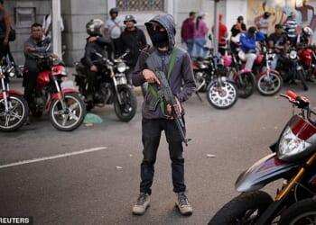Plain-clothed gunmen were seen patrolling the streets of the capital, Caracas, calling for the release of Venezuela's President Nicolas Maduro